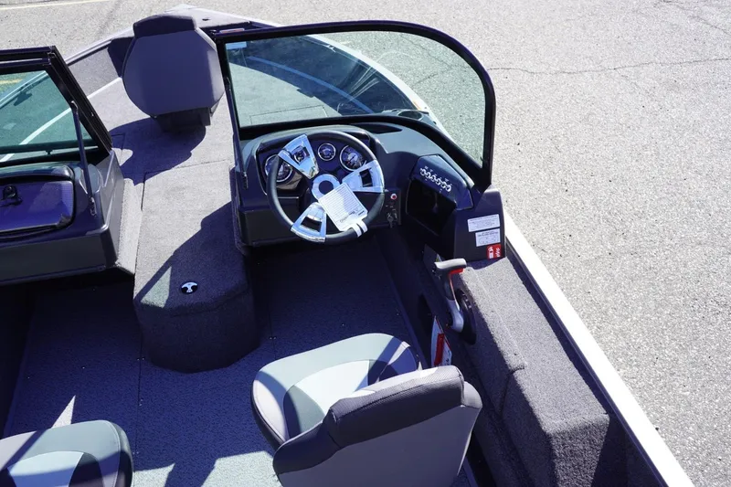 Slide: The Image of 2026 Lowe Fishing Machine 1775WT interior with steering wheel and seating. - 24