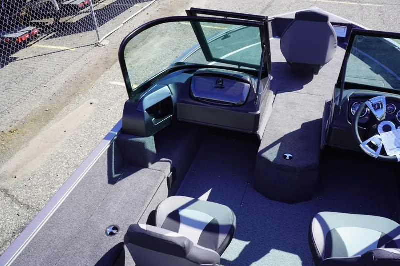 Slide: The Image of 2026 Lowe Fishing Machine 1775WT interior with seating and steering console. - 25