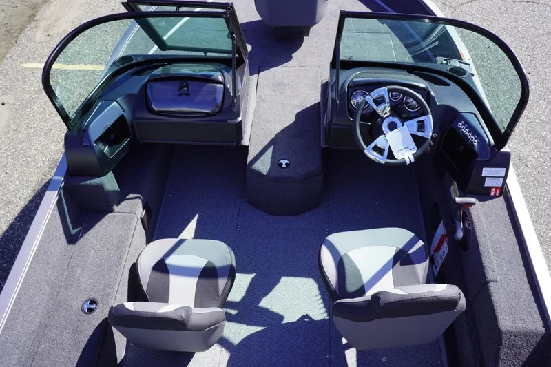 Slide: The Image of 2026 Lowe Fishing Machine 1775WT interior with dual seats and steering console. - 26