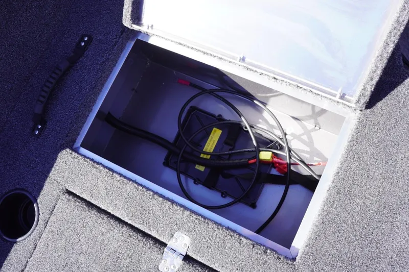 Slide: The Image of Open storage compartment in 2026 Lowe Fishing Machine 1775WT boat, showing cables and wiring. - 29