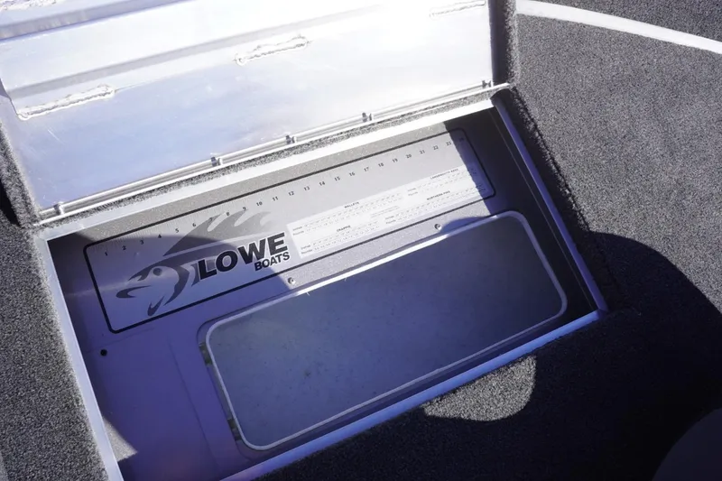 Slide: The Image of 2026 Lowe Fishing Machine 1775WT boat storage compartment with ruler and logo. - 32