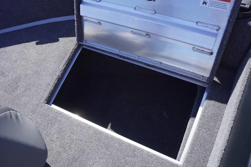 Slide: The Image of 2026 Lowe Fishing Machine 1775WT boat storage compartment with open hatch. - 33