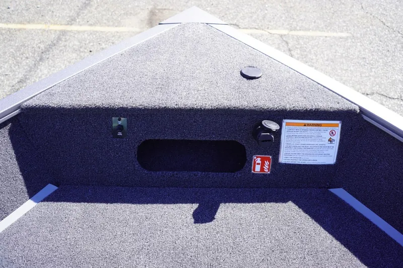 Slide: The Image of 2026 Lowe Fishing Machine 1775WT boat interior with carpeted deck and safety features. - 34