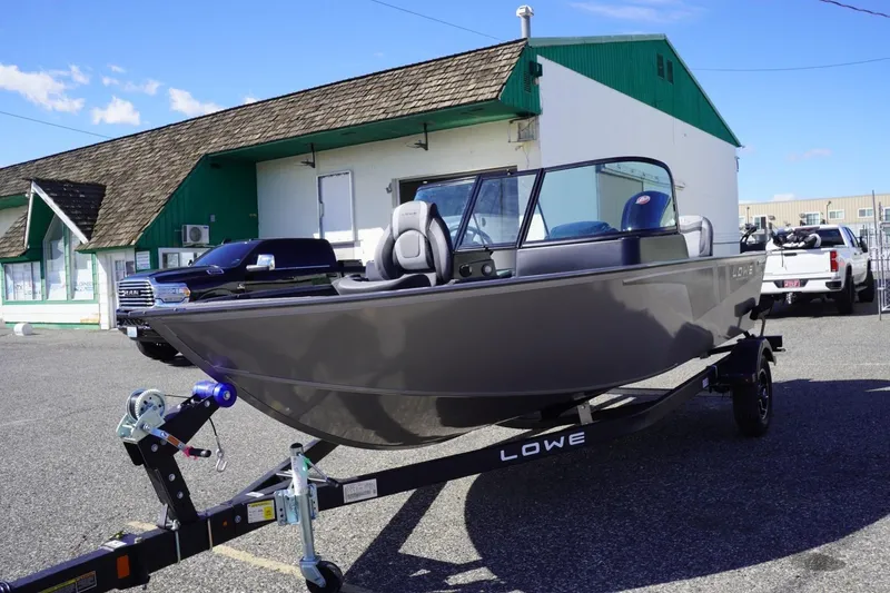 Slide: The Image of 2026 Lowe Fishing Machine 1775WT boat on trailer in parking lot. - 4