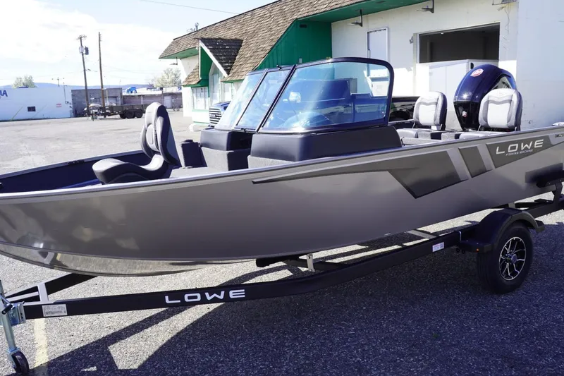 Slide: The Image of 2026 Lowe Fishing Machine 1775WT boat on trailer, parked outdoors. - 5