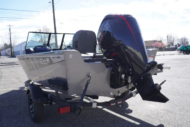 Slide: The Image of 2026 Lowe Fishing Machine 1775WT boat with powerful outboard motor in a parking lot. - 7