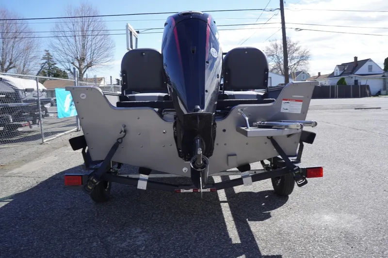 Slide: The Image of 2026 Lowe Fishing Machine 1775WT boat rear view with motor in parking lot. - 8