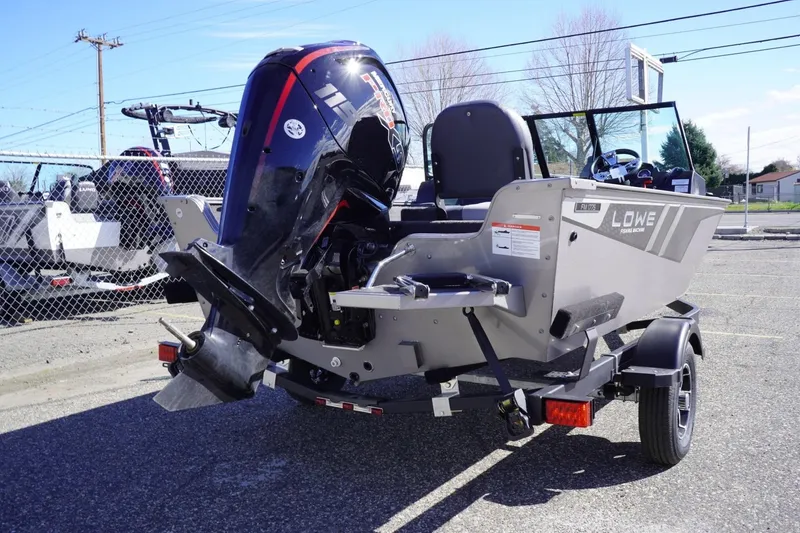 Slide: The Image of 2026 Lowe Fishing Machine 1775WT boat with powerful outboard motor in parking lot. - 9
