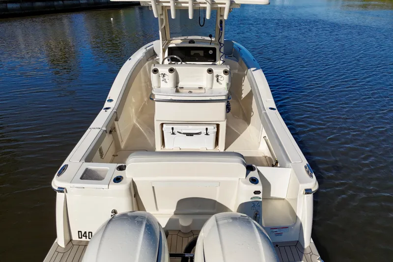 Slide: The Image of 2022 Scout 277 LXF boat on water, showcasing spacious deck and dual engines. - 11