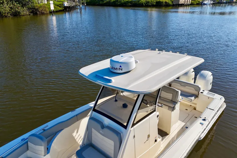 Slide: The Image of 2022 Scout 277 LXF boat on calm water, featuring a sleek design and modern amenities. - 12