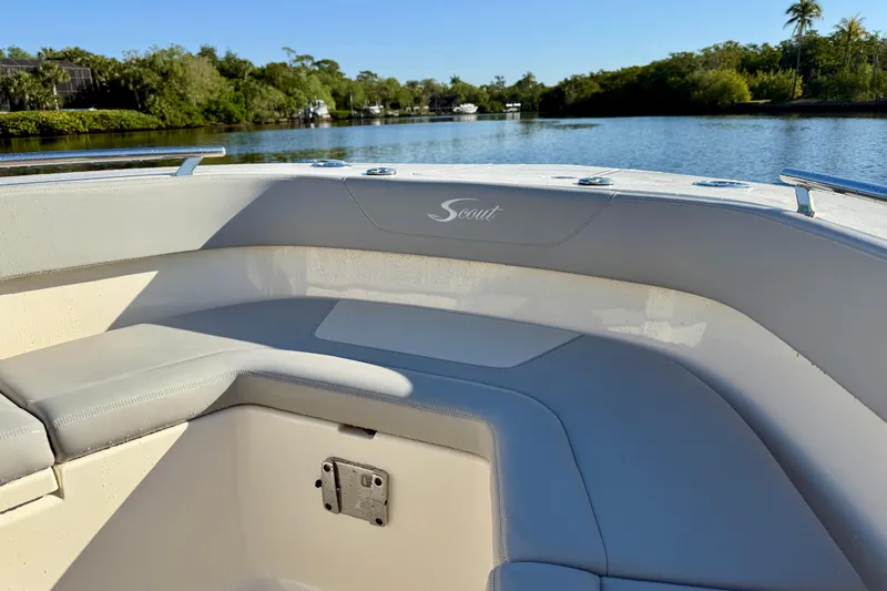 Slide: The Image of 2022 Scout 277 LXF boat interior with seating, on a calm river. - 14