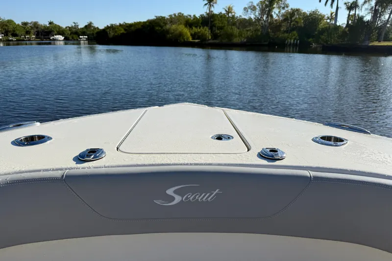 Slide: The Image of 2022 Scout 277 LXF boat on calm water, showcasing sleek design and luxury features. - 15