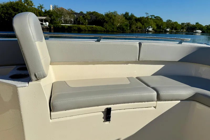 Slide: The Image of 2022 Scout 277 LXF boat interior with cushioned seating and cup holders. - 18