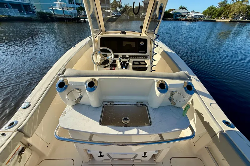Slide: The Image of 2022 Scout 277 LXF boat interior with steering console and water view. - 26