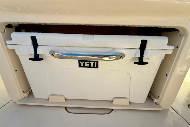 Slide: The Image of YETI cooler stored in a 2022 Scout 277 LXF boat compartment. - 28