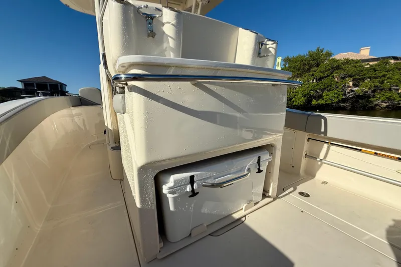 Slide: The Image of 2022 Scout 277 LXF boat interior with storage compartment and cooler. - 29