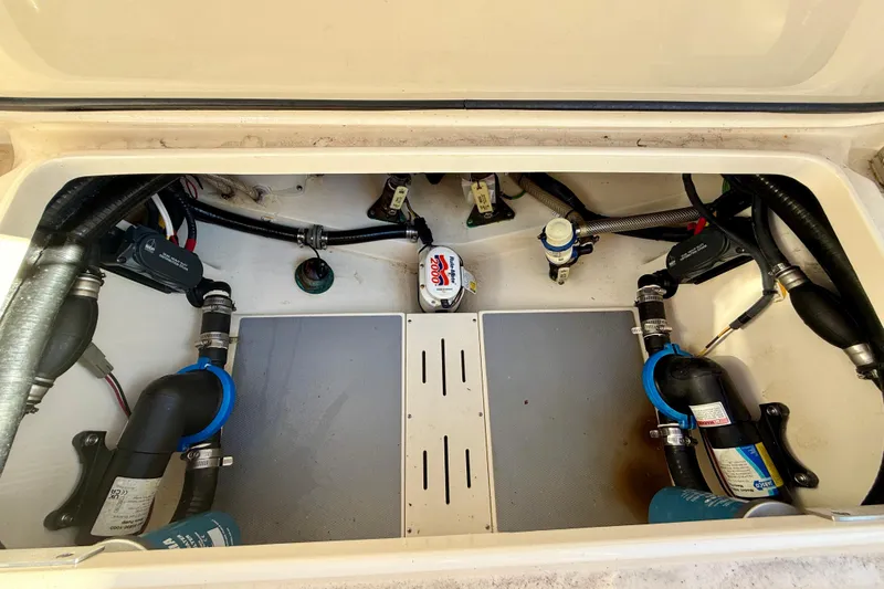 Slide: The Image of 2022 Scout 277 LXF boat compartment showcasing internal wiring and plumbing components. - 36