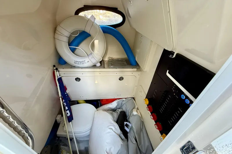 Slide: The Image of Interior of 2022 Scout 277 LXF boat with safety equipment and storage. - 38