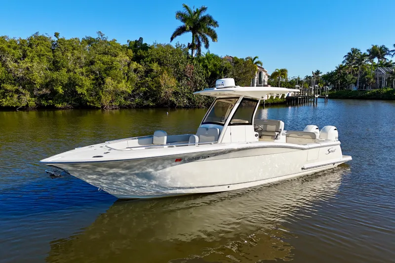 Slide: The Image of 2022 Scout 277 LXF boat on calm water. - 6