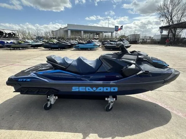 The Image of 2026 Sea-Doo GTX jet ski parked outdoors on a sunny day. - 1