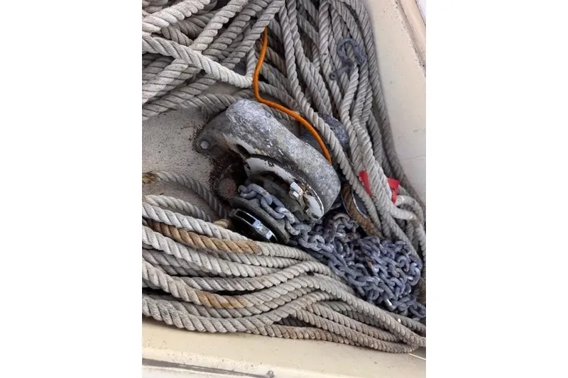 Slide: The Image of Coiled ropes and chains on a 1977 Islander 32 sailboat deck. - 10