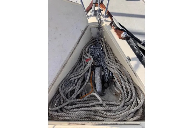Slide: The Image of Coiled ropes and anchor chain on 1977 Islander 32 sailboat deck. - 11