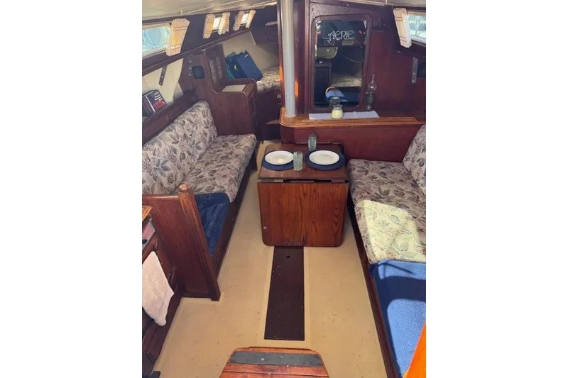 Slide: The Image of 1977 Islander 32 sailboat interior with floral upholstery and wooden furnishings. - 20
