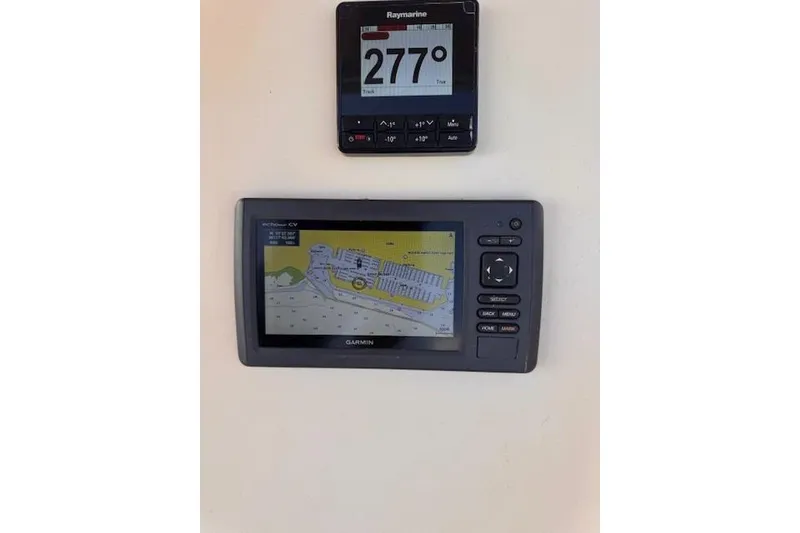 Slide: The Image of Navigation instruments on a 1977 Islander 32 sailboat, featuring Raymarine and Garmin displays. - 7