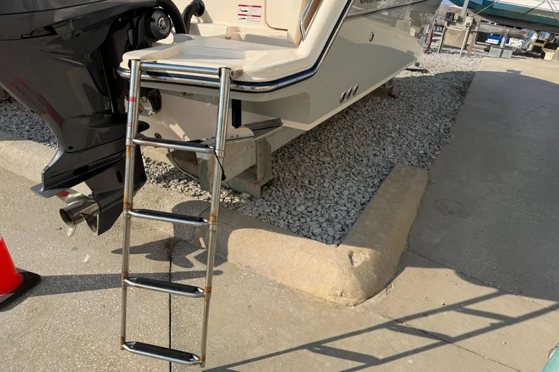 Slide: The Image of 2024 Grady-White Fisherman 236 boat with ladder and outboard motor on display. - 16