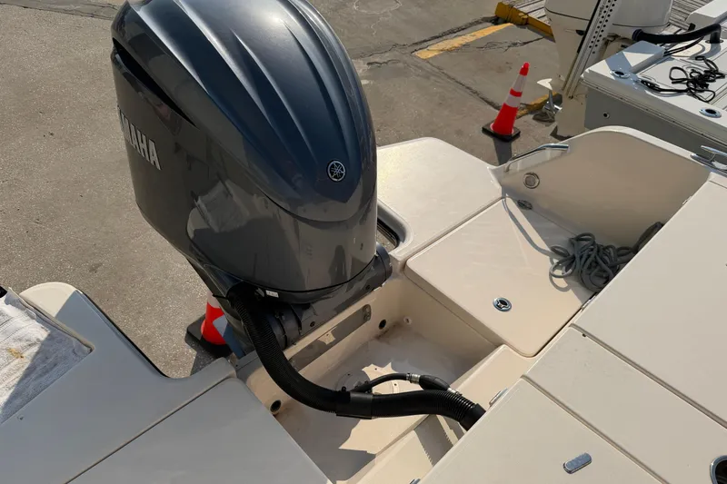 Slide: The Image of 2024 Grady-White Fisherman 236 boat with Yamaha outboard motor, docked on concrete. - 24