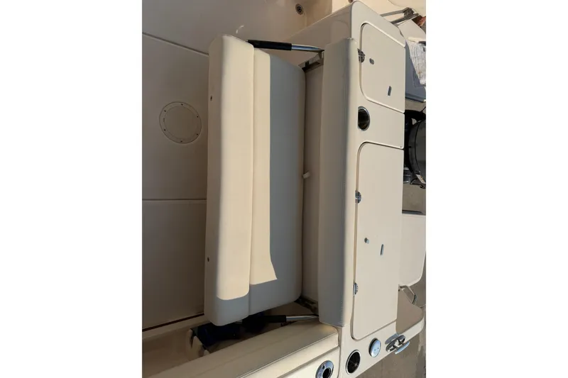 Slide: The Image of 2024 Grady-White Fisherman 236 boat interior with beige seating and storage compartments. - 25