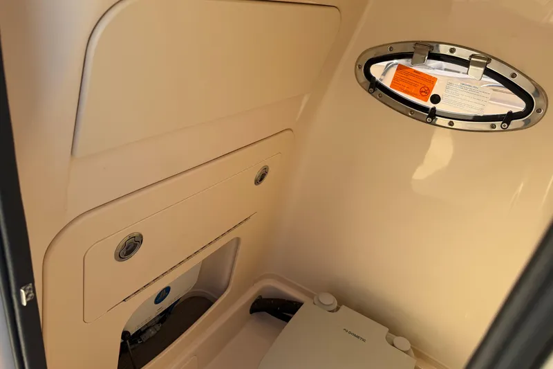 Slide: The Image of 2024 Grady-White Fisherman 236 interior cabin with storage and porthole window. - 27