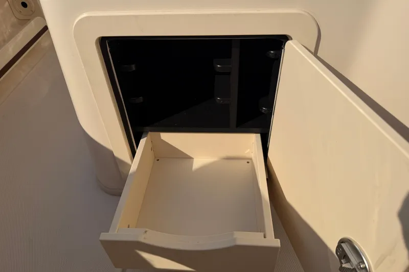 Slide: The Image of 2024 Grady-White Fisherman 236 storage compartment with open drawer. - 35
