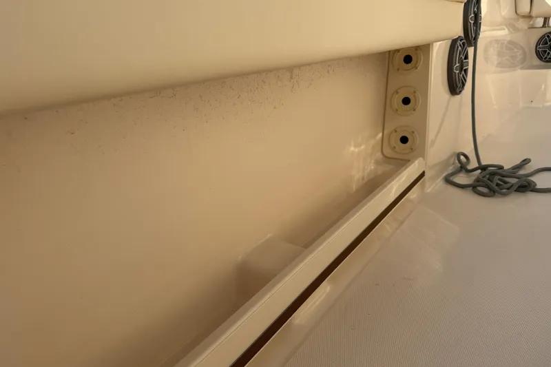 Slide: The Image of 2024 Grady-White Fisherman 236 boat interior detail with rod holders and speakers. - 36