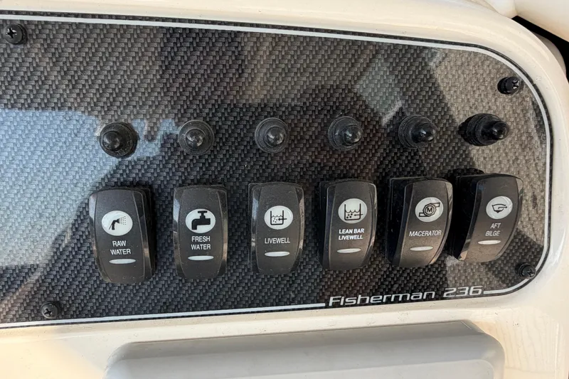 Slide: The Image of Control panel of 2024 Grady-White Fisherman 236 boat with labeled switches. - 42