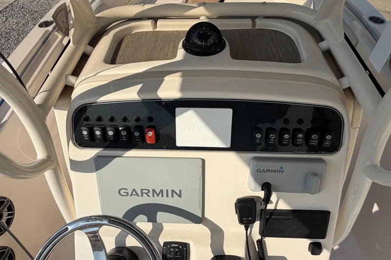 Slide: The Image of 2024 Grady-White Fisherman 236 dashboard with Garmin navigation system and controls. - 48
