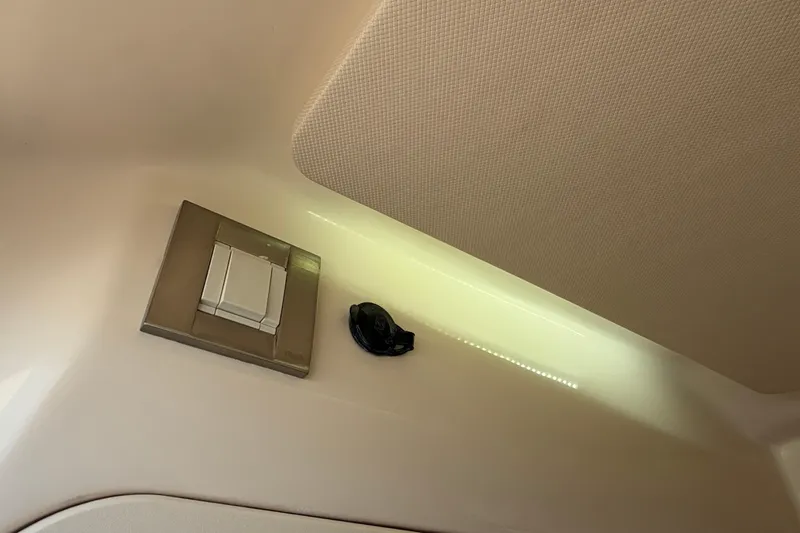 Slide: The Image of 2024 Grady-White Fisherman 236 interior detail with light switch and textured ceiling. - 59