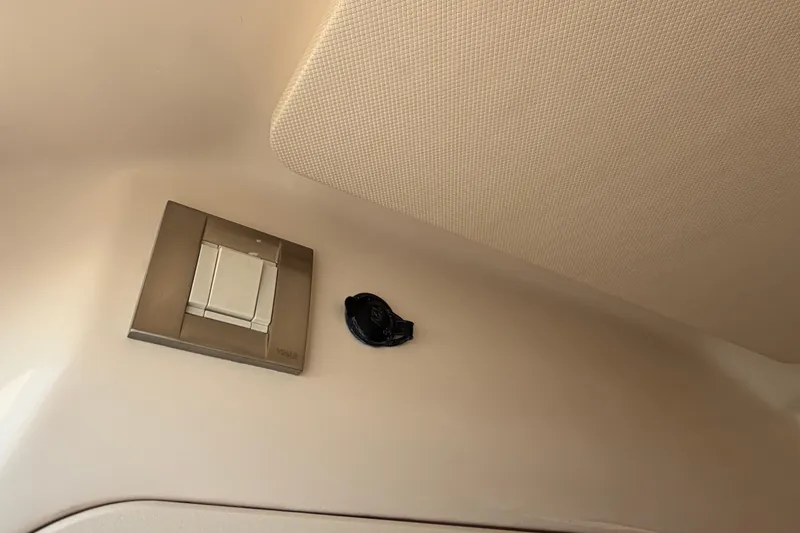 Slide: The Image of Interior detail of 2024 Grady-White Fisherman 236 boat, featuring a switch and textured ceiling. - 60