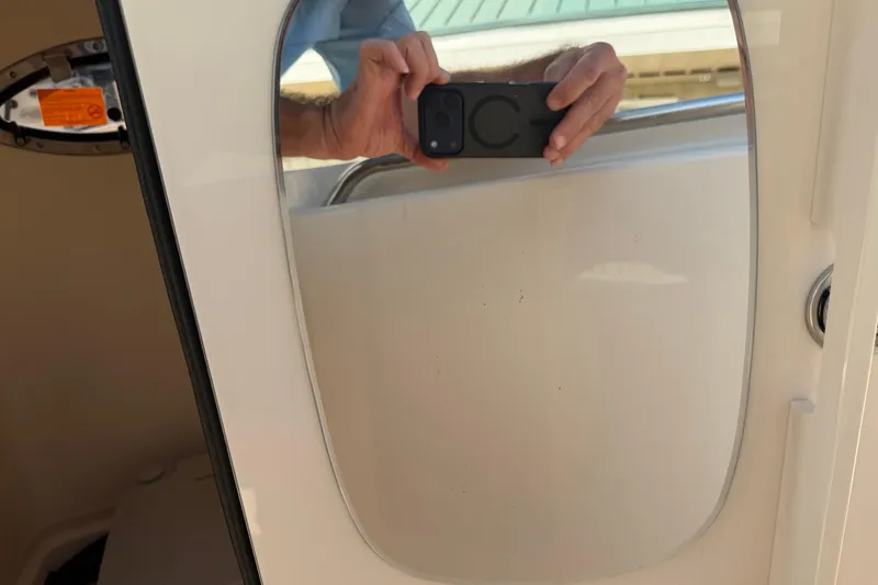 Slide: The Image of Reflection in a mirror on a 2024 Grady-White Fisherman 236 boat. - 62