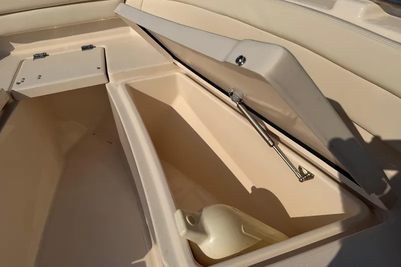 Slide: The Image of 2024 Grady-White Fisherman 236 boat storage compartment with open hatch and hydraulic support. - 63