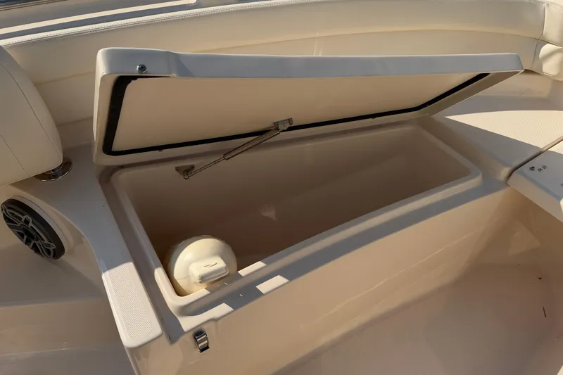 Slide: The Image of 2024 Grady-White Fisherman 236 boat storage compartment with open lid, showcasing interior space. - 64