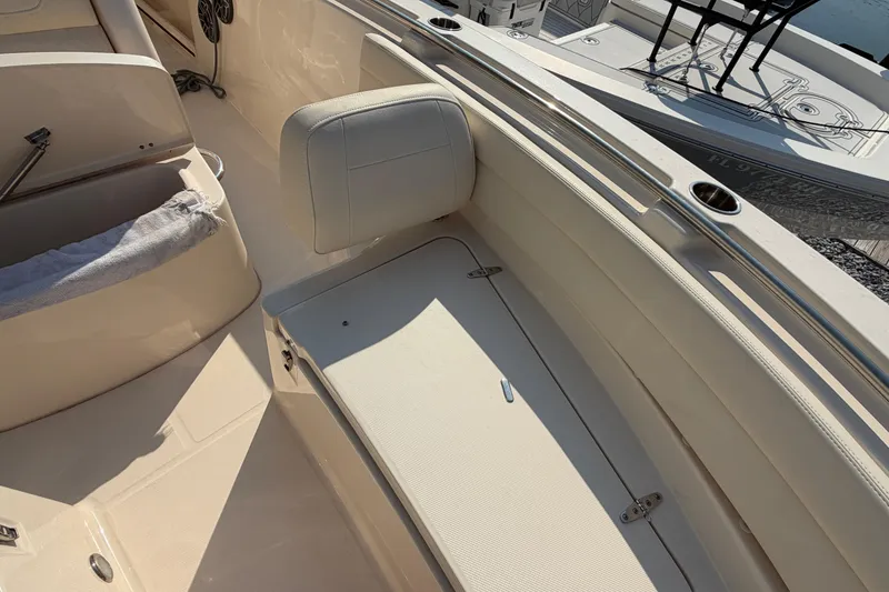 Slide: The Image of 2024 Grady-White Fisherman 236 boat interior with cushioned seating and stainless steel railings. - 65