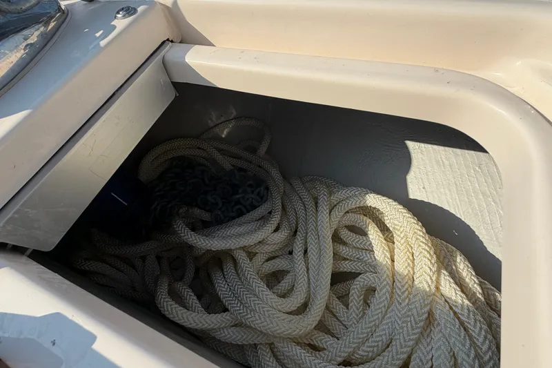 Slide: The Image of Storage compartment with rope and chain on 2024 Grady-White Fisherman 236 boat. - 70