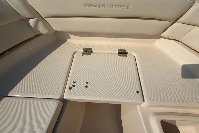 Slide: The Image of 2024 Grady-White Fisherman 236 boat interior with cushioned seating and storage hatch. - 75