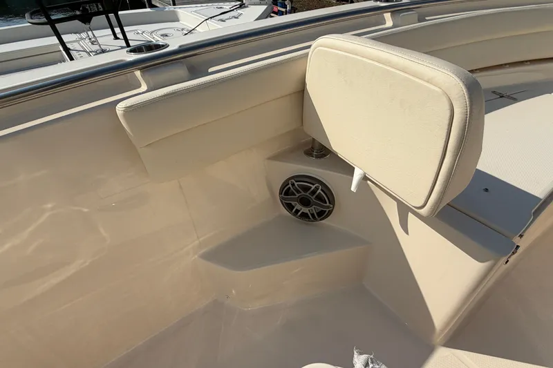 Slide: The Image of 2024 Grady-White Fisherman 236 boat interior with cushioned seating and speaker. - 76