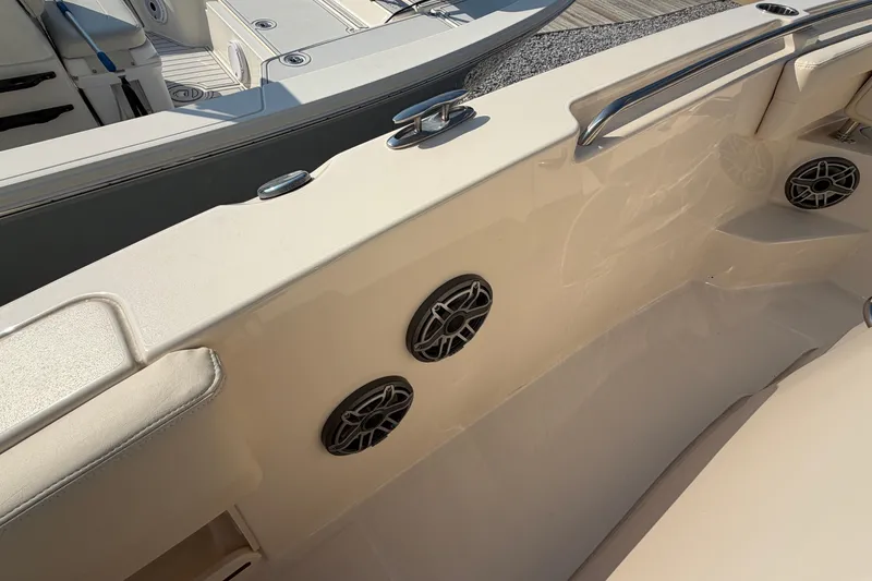 Slide: The Image of 2024 Grady-White Fisherman 236 boat interior with speakers and seating area. - 80