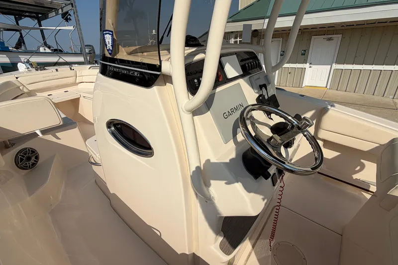 Slide: The Image of 2024 Grady-White Fisherman 236 boat cockpit with Garmin navigation system and steering wheel. - 81