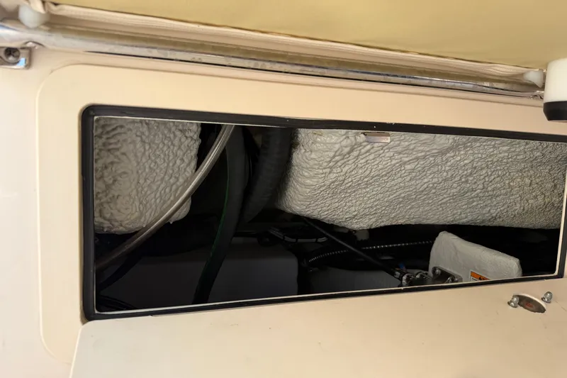 Slide: The Image of 2024 Grady-White Fisherman 236 interior compartment with insulation and wiring visible. - 84