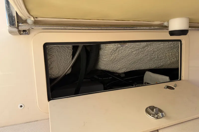 Slide: The Image of 2024 Grady-White Fisherman 236 boat storage compartment with open hatch and visible interior. - 85
