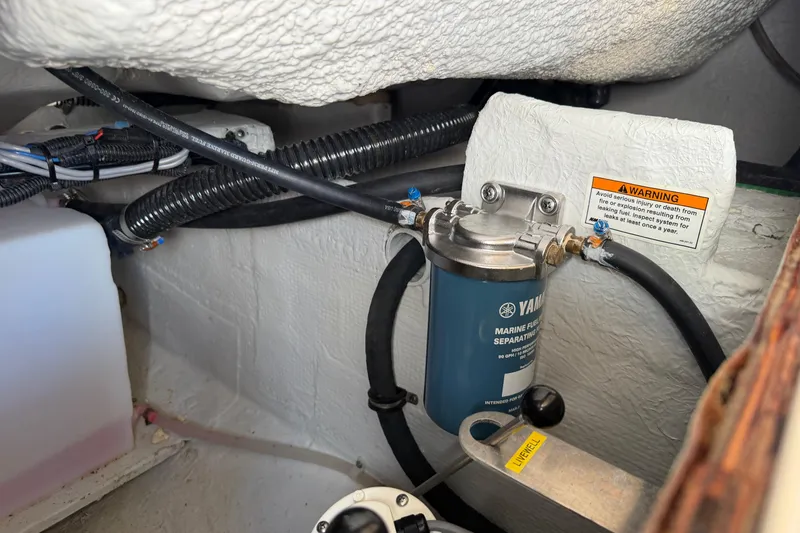 Slide: The Image of 2024 Grady-White Fisherman 236 engine compartment with Yamaha marine fuel filter. - 86